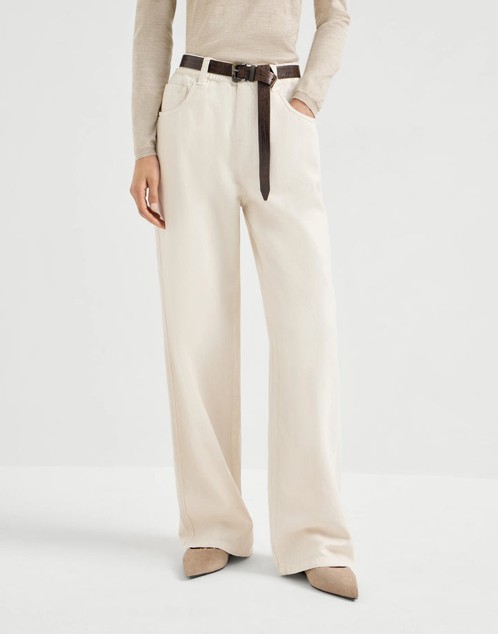 Person wearing beige wide-leg pants with a belt on a white background
