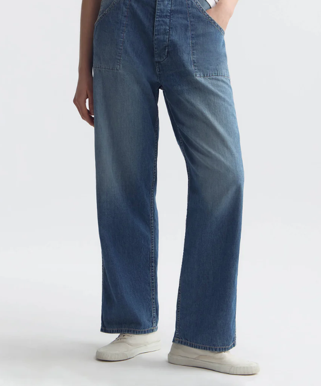 Person wearing blue jeans on a white background