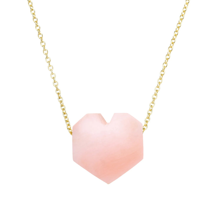Pink heart-shaped pendant on a gold chain against a white background