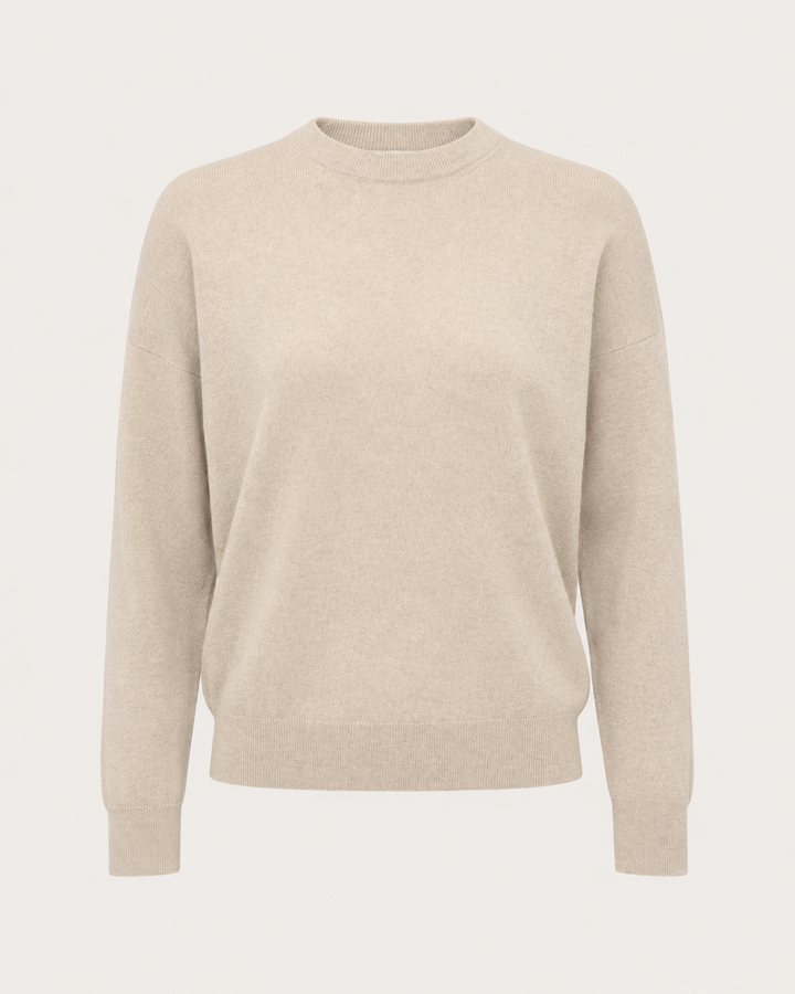 A light beige crewneck sweater with long sleeves, shown on a clean, solid off-white background.