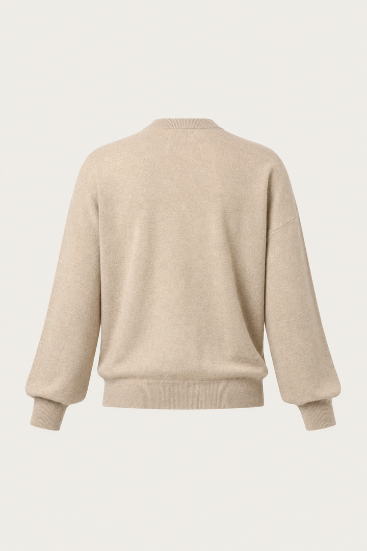 A light beige knit sweater shown from the back, featuring a crew neck, long sleeves with ribbed cuffs, and a ribbed hem, displayed against a solid off-white background.
