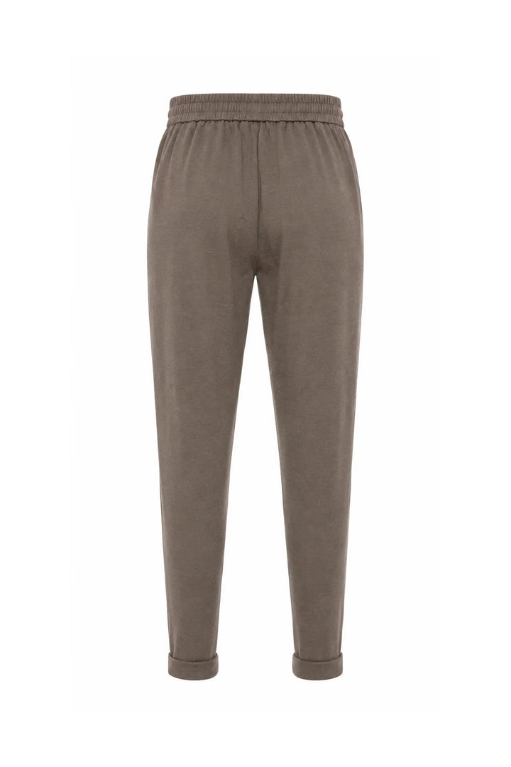 A pair of relaxed-fit jogger pants in a muted taupe-brown color, shown from the back against a plain white background.