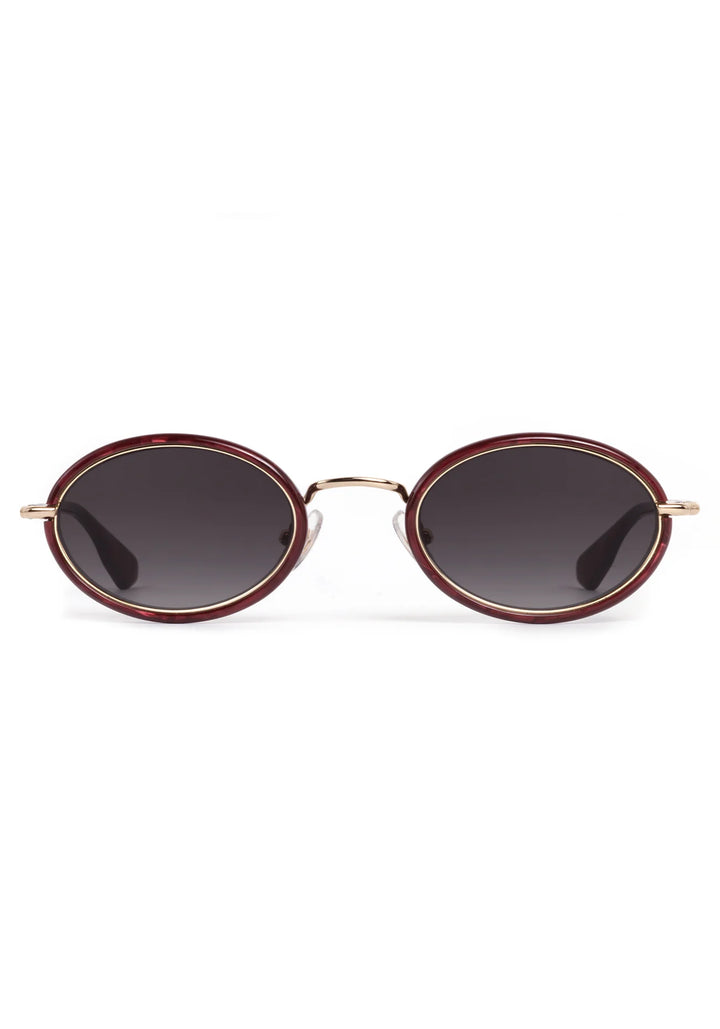 Round sunglasses with gold frame and dark lenses on a white background