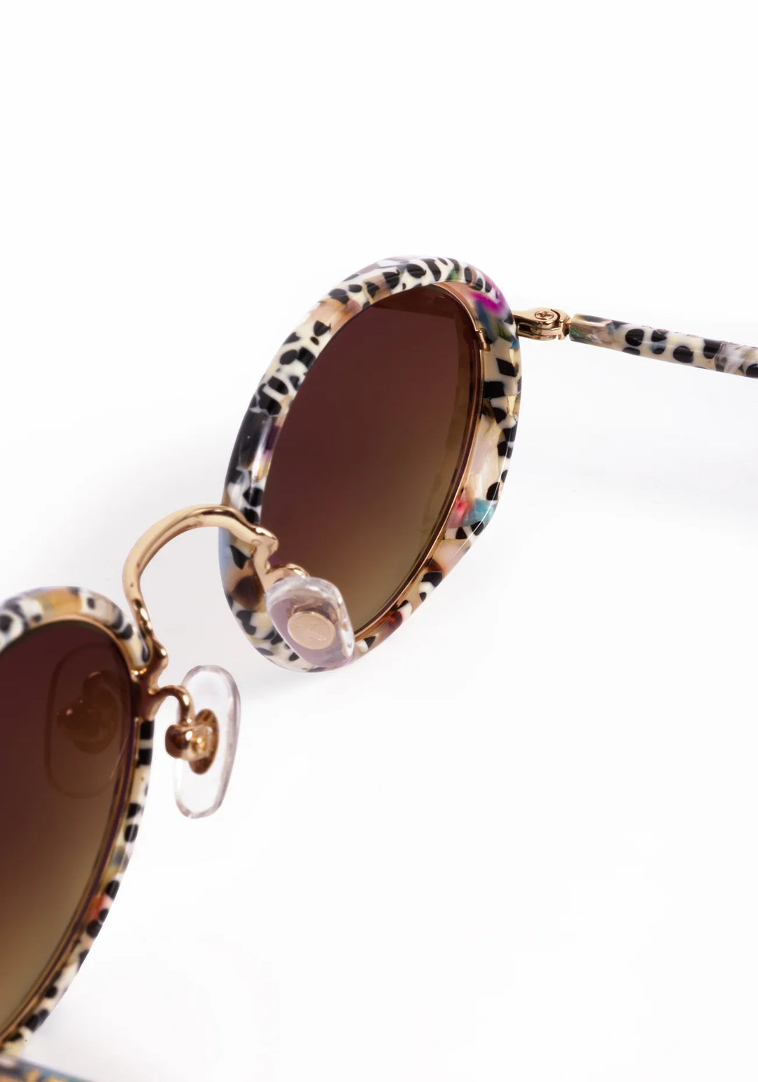 Sunglasses with leopard print frame and brown lenses on a white background