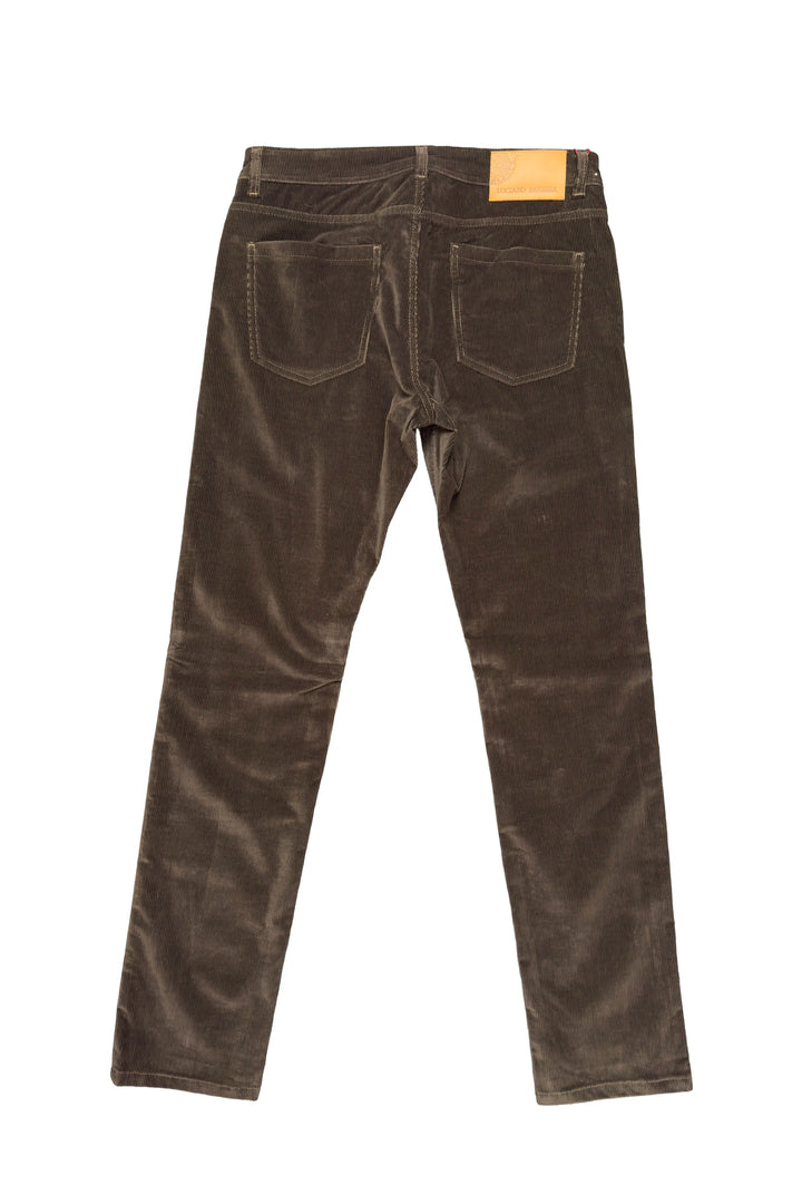Back view of dark brown corduroy jeans on a white background, showing the back pockets and a small tan leather patch at the waistband.
