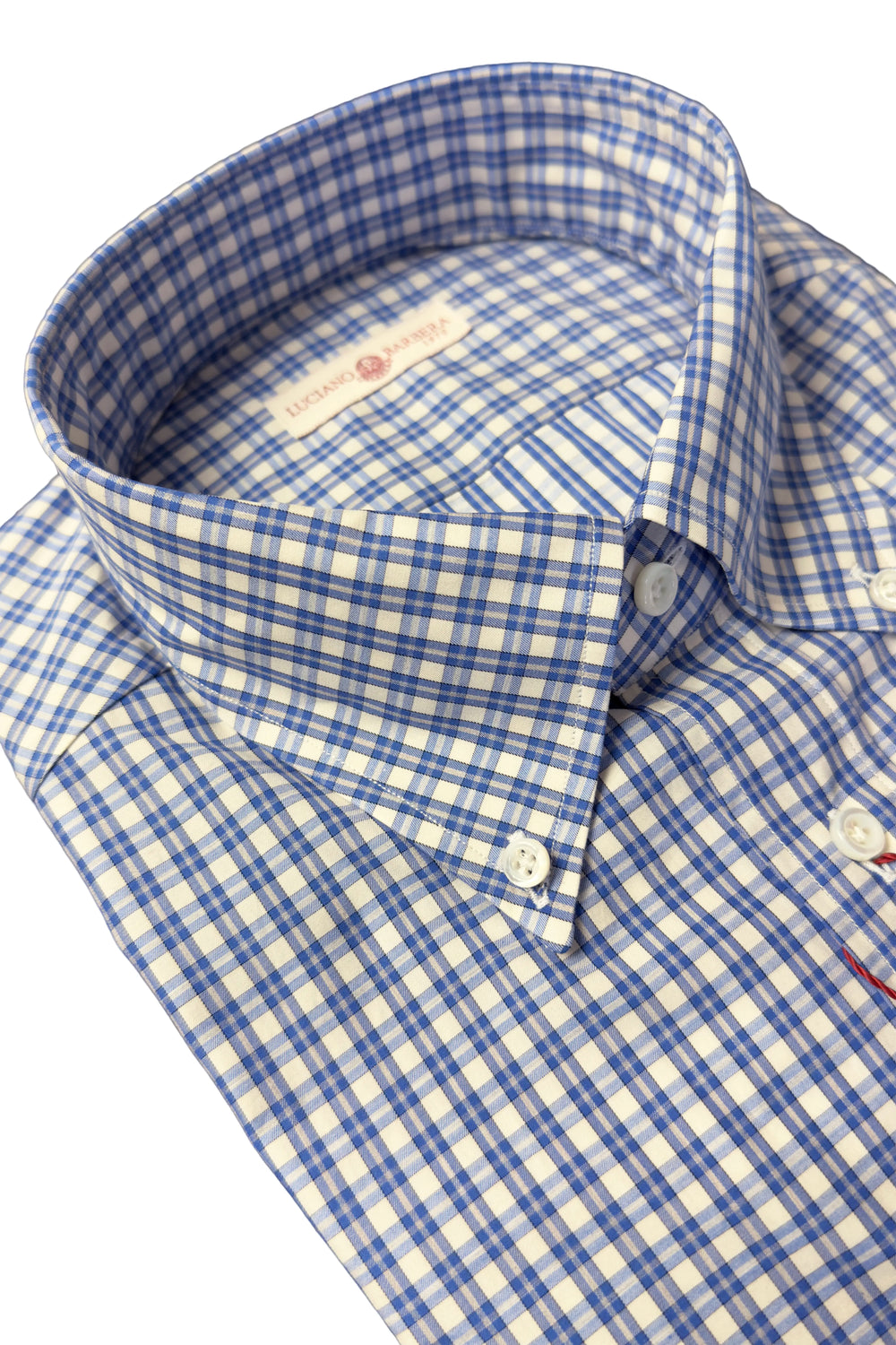 Close-up of a men's button-down shirt with a blue and white gingham check pattern, showing the collar, button-down front, and white buttons.