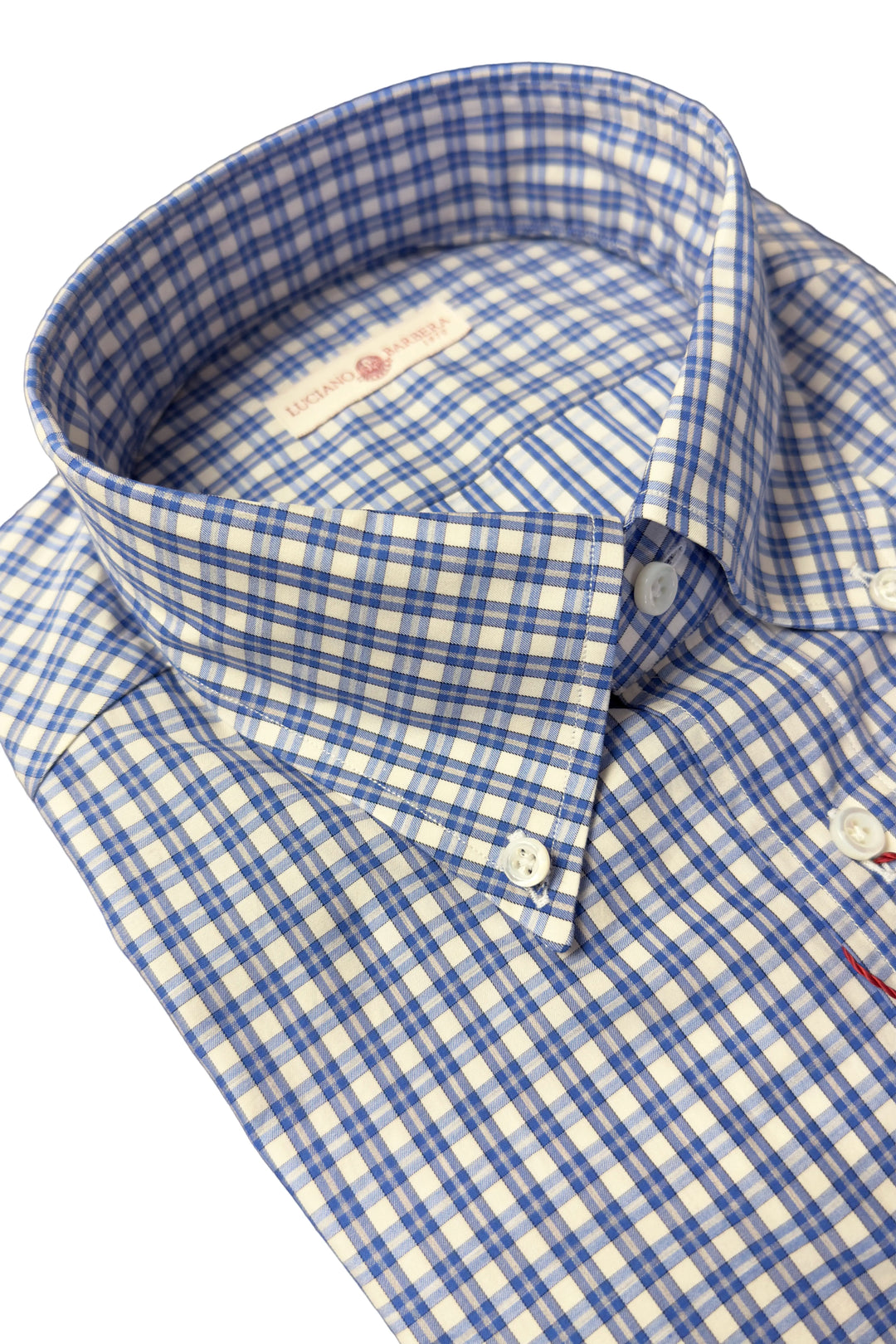 Close-up of a men's button-down shirt with a blue and white gingham check pattern, showing the collar, button-down front, and white buttons.