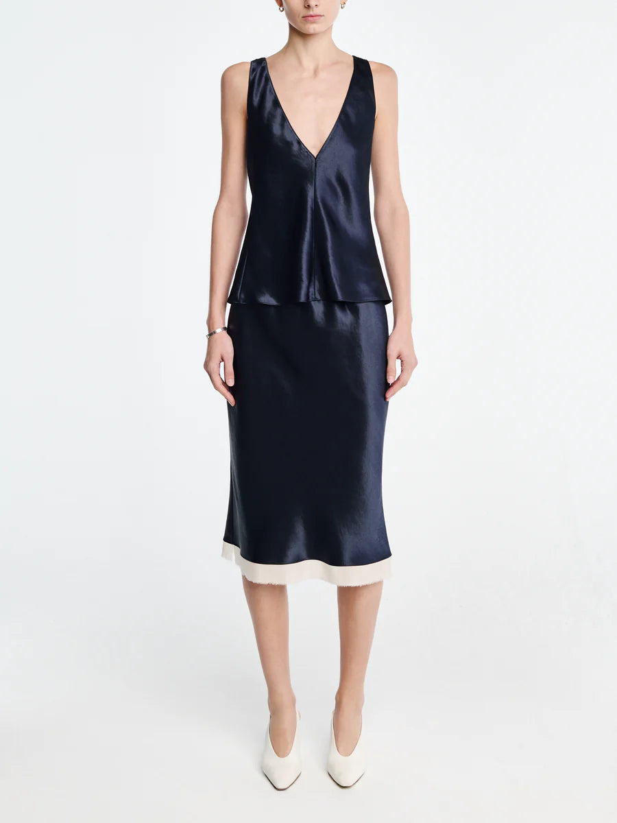 Navy satin dress with a white hem on a plain background