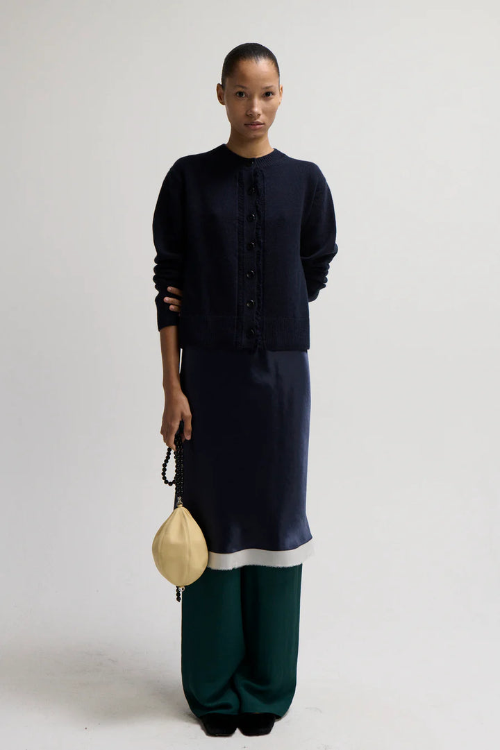 Person wearing a dark blue outfit with a white background