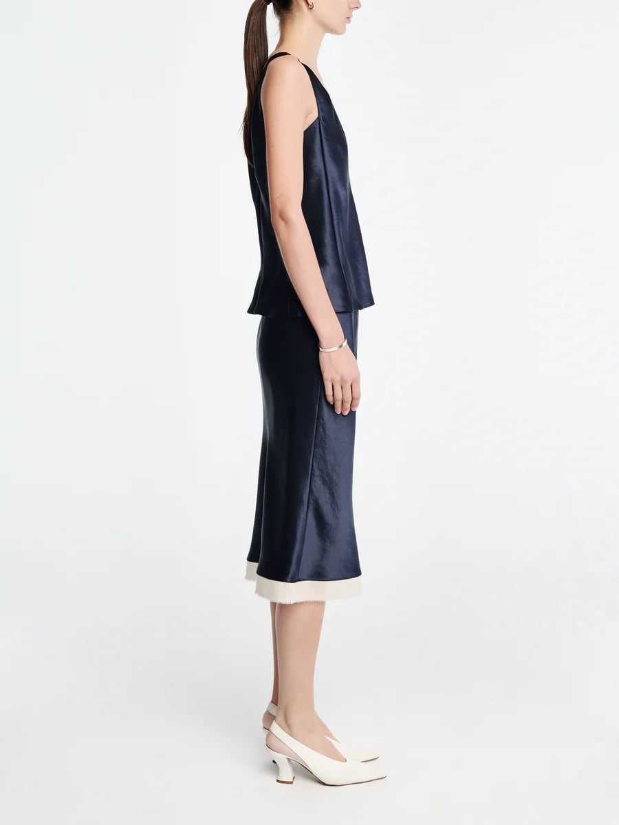Woman wearing a navy blue dress with a white background