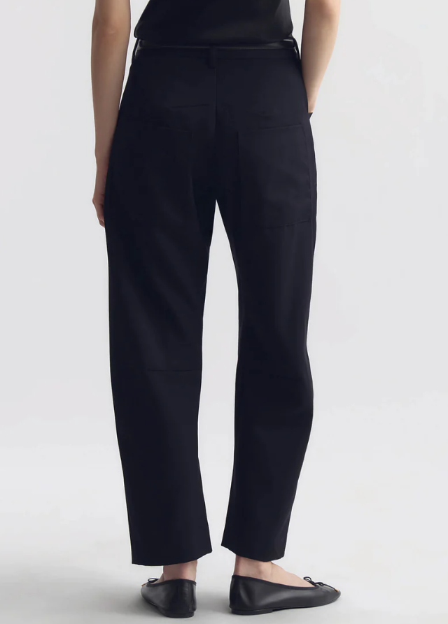 Person wearing black pants on a white background