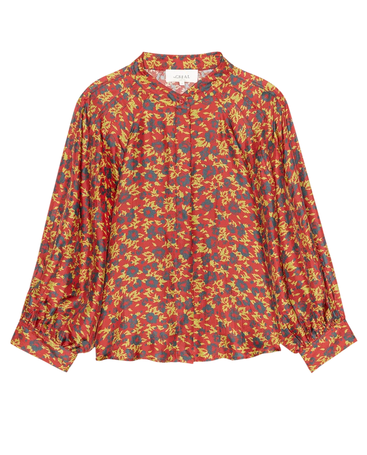 A long-sleeve button-up blouse by Chanel, featuring an all-over abstract floral pattern in red, yellow, and blue on a white background.