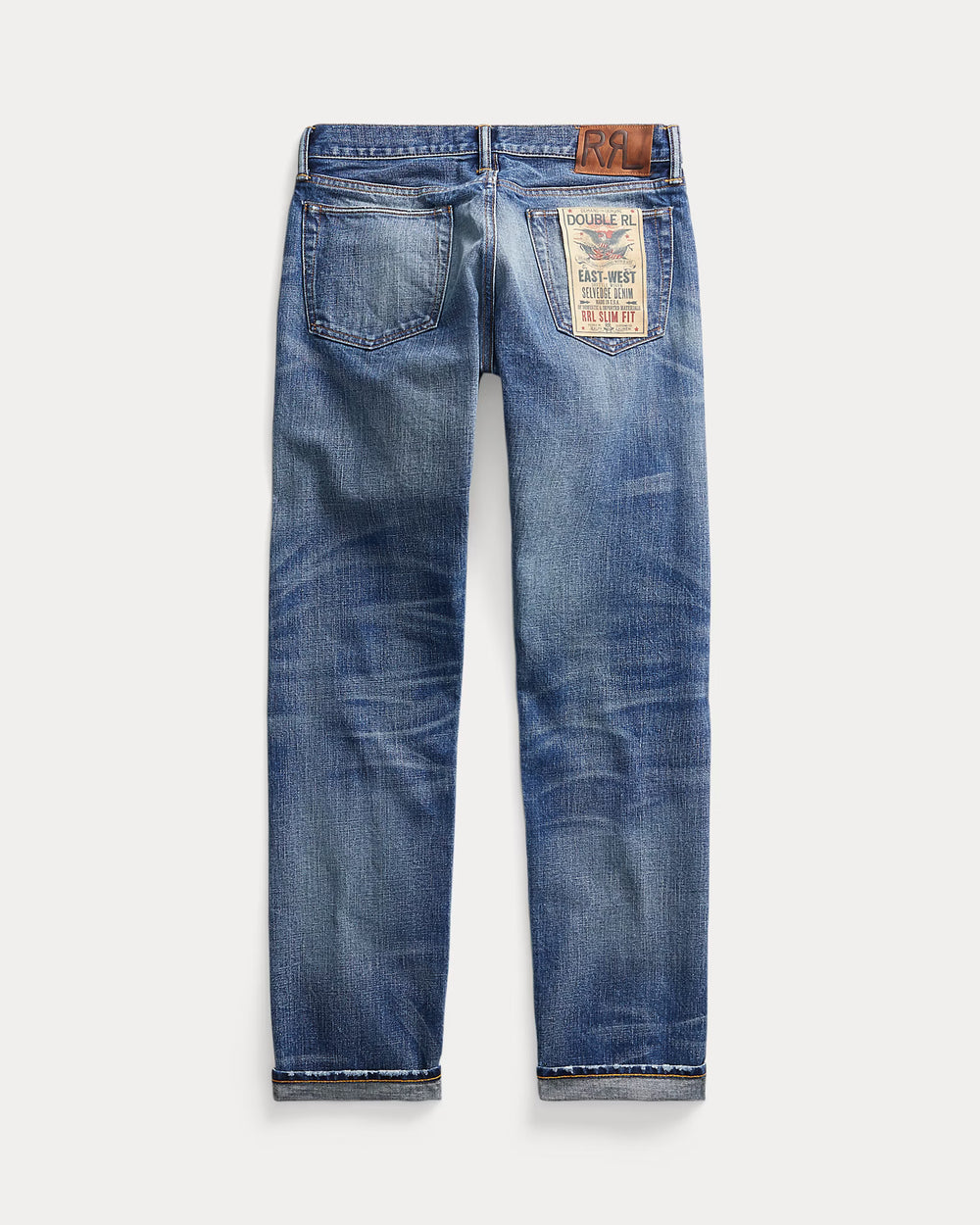 Pair of blue jeans with a brand label on a white background