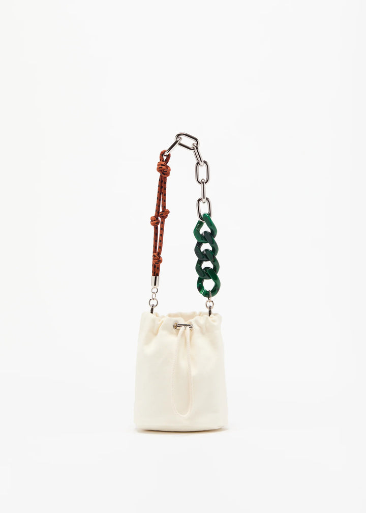 Small white drawstring bag with a green and brown chain strap on a white background