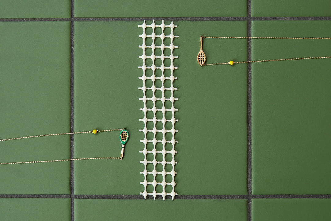 Tennis court with a green mat, racket, and ball on a green surface