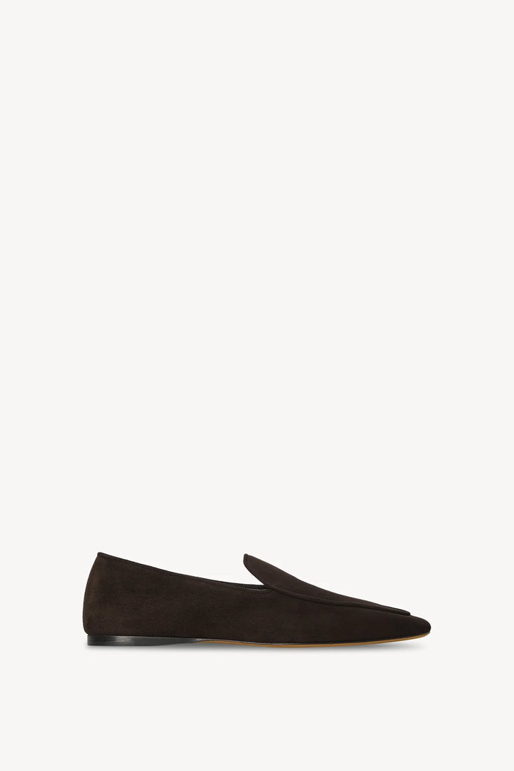 Black suede loafer on a white background