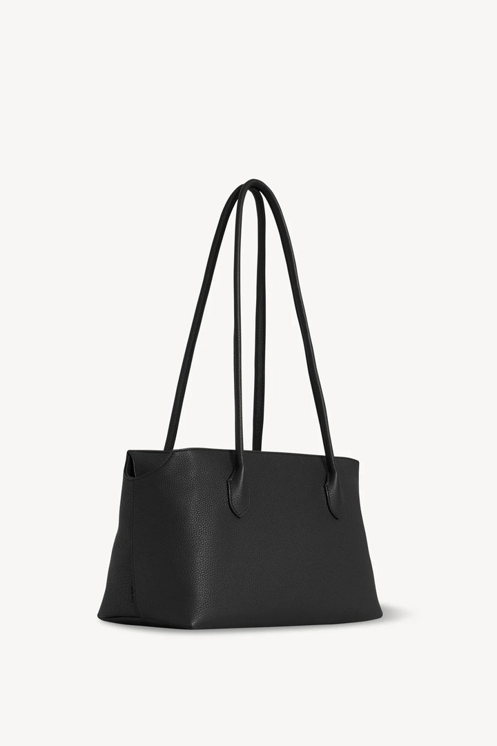 Black handbag with shoulder straps on a white background