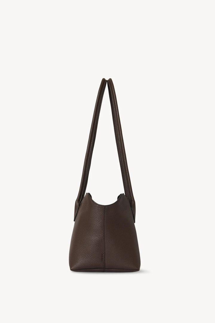 Brown leather handbag with a shoulder strap on a white background