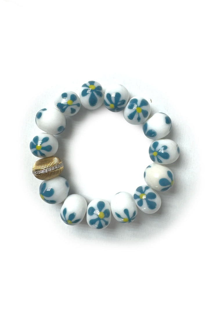 White bracelet with blue floral patterns on a white background