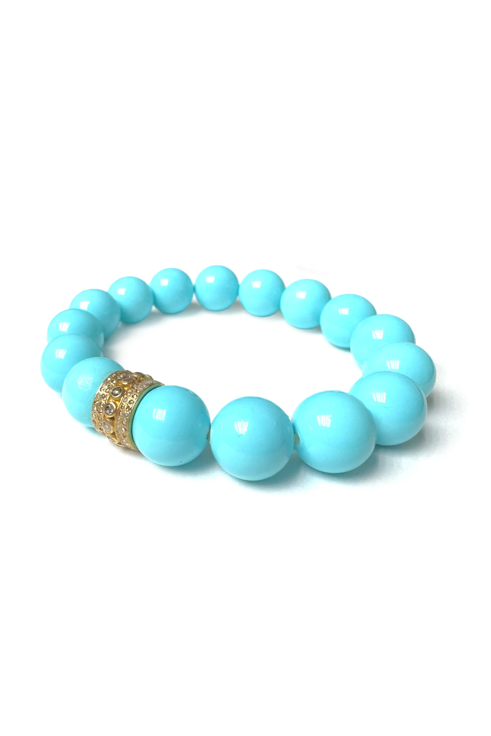 Turquoise beaded bracelet with a gold accent on a white background