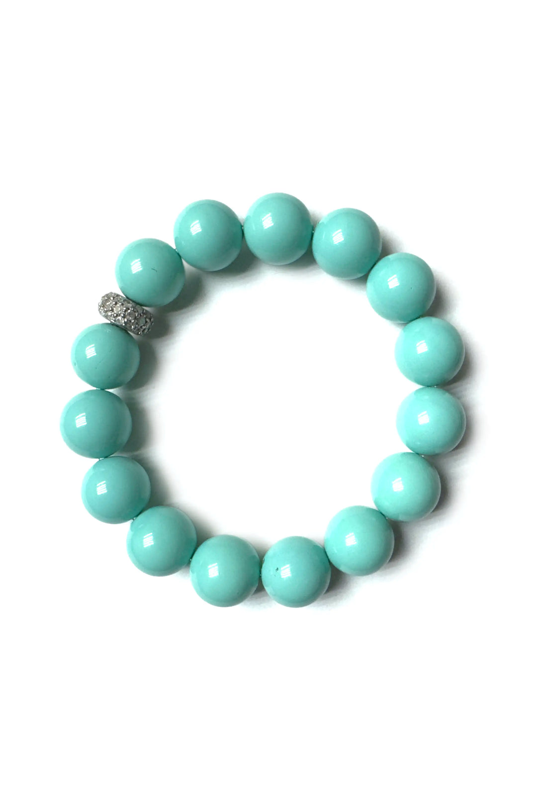 Turquoise beaded bracelet with a silver clasp on a white background