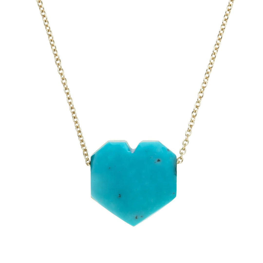 Turquoise heart-shaped pendant on a gold chain against a white background