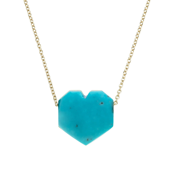 Turquoise heart-shaped pendant on a gold chain against a white background