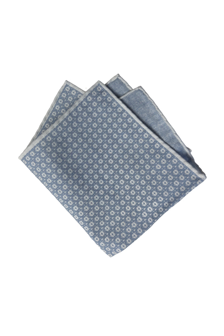 Two folded blue patterned cloths on a white background