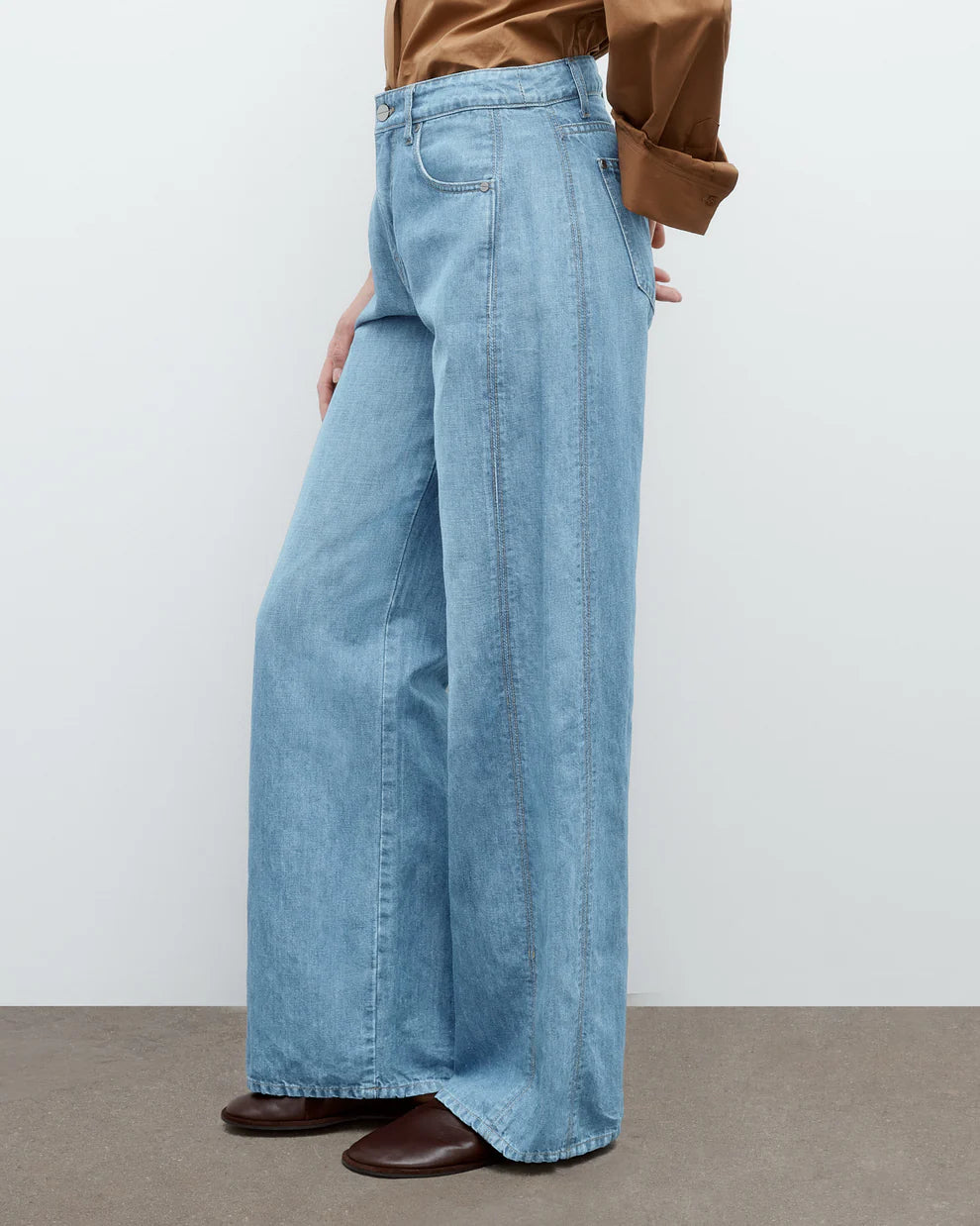 Light blue wide-leg jeans worn by a person on a plain background