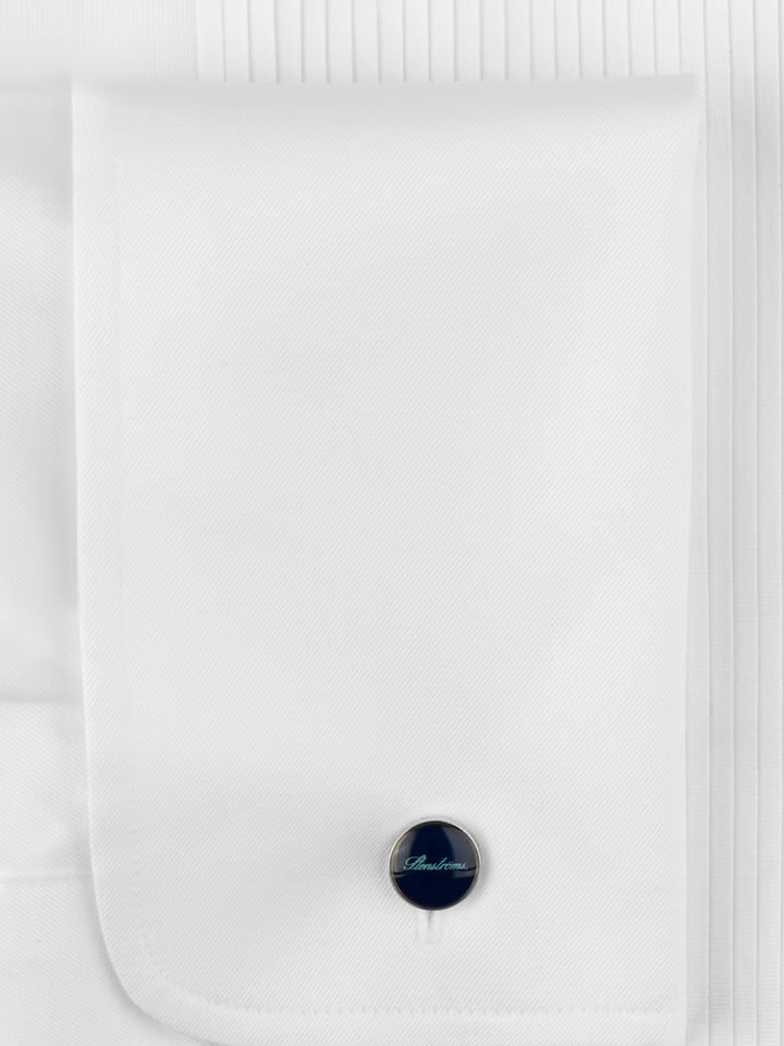White shirt with a black cufflink on a white background