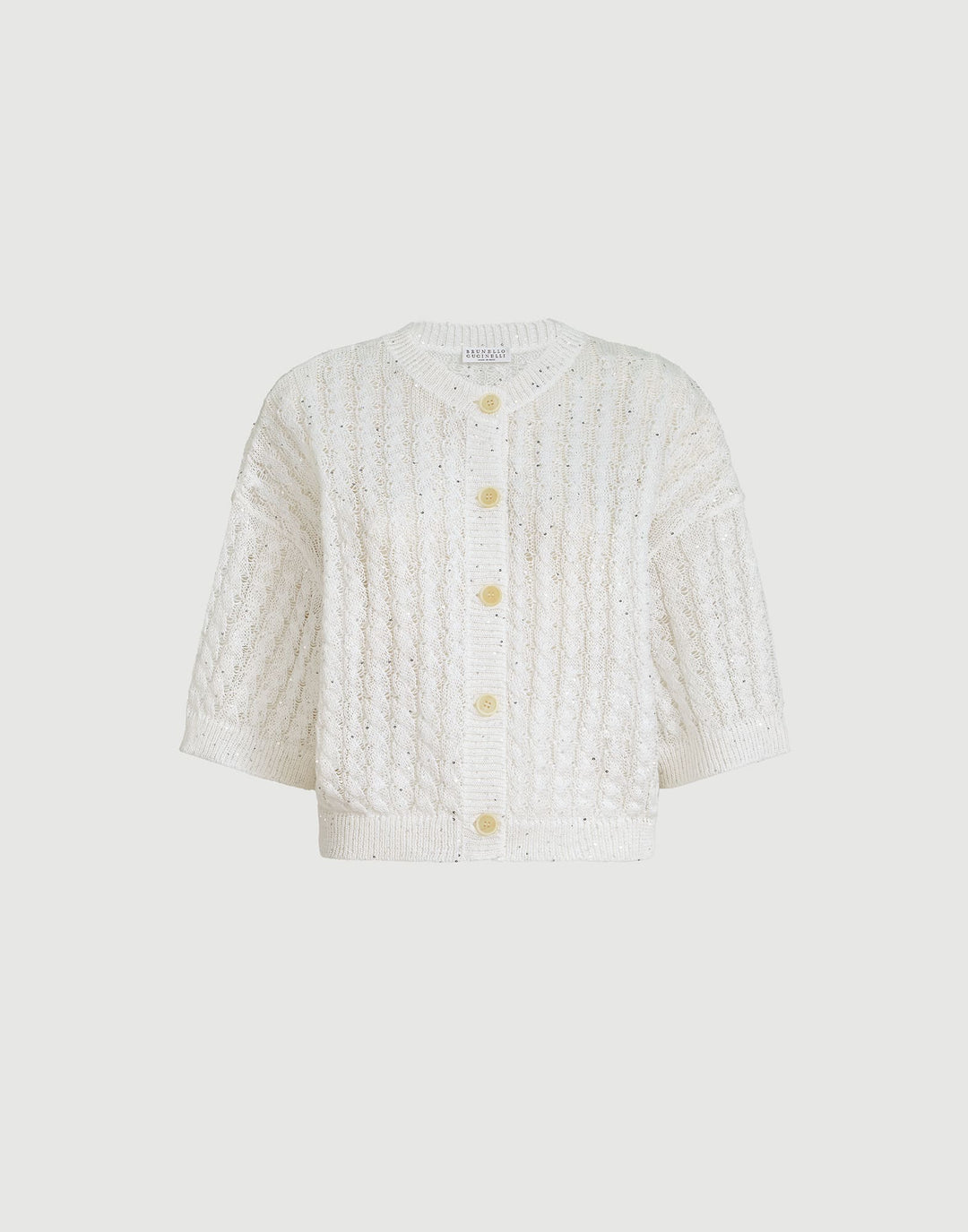 White textured cardigan with gold buttons on a light gray background