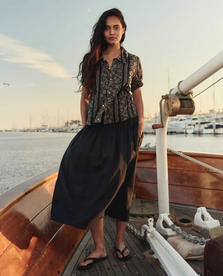Woman standing on a boat at sunset