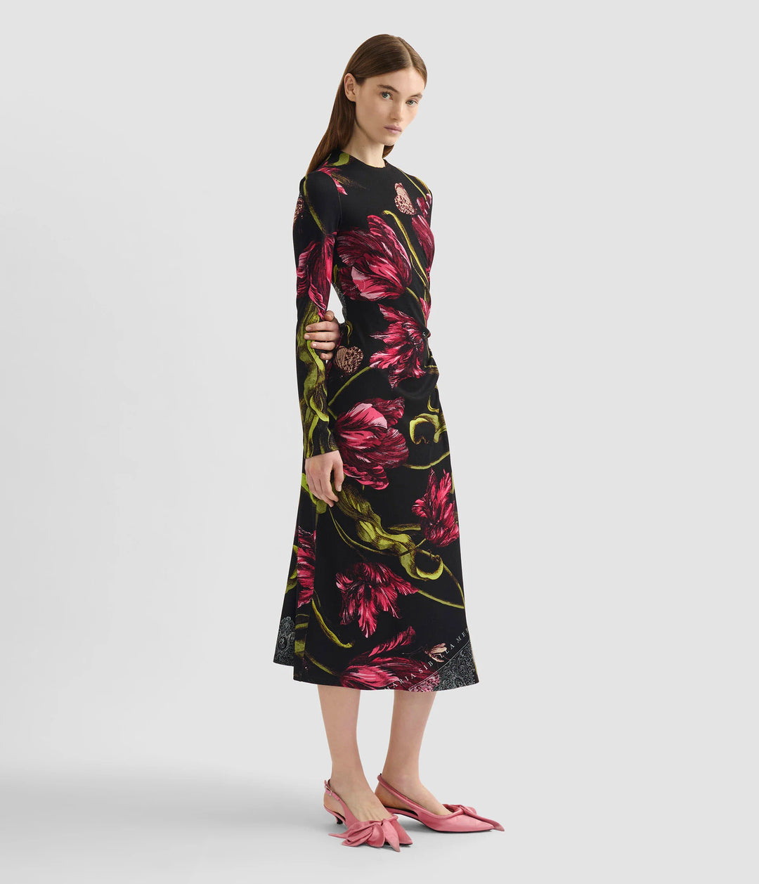 Woman wearing a black floral dress on a white background