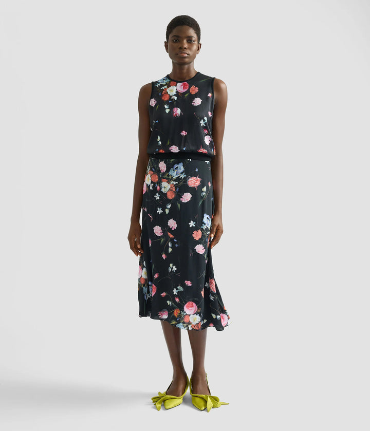 Woman wearing a floral dress with a plain background