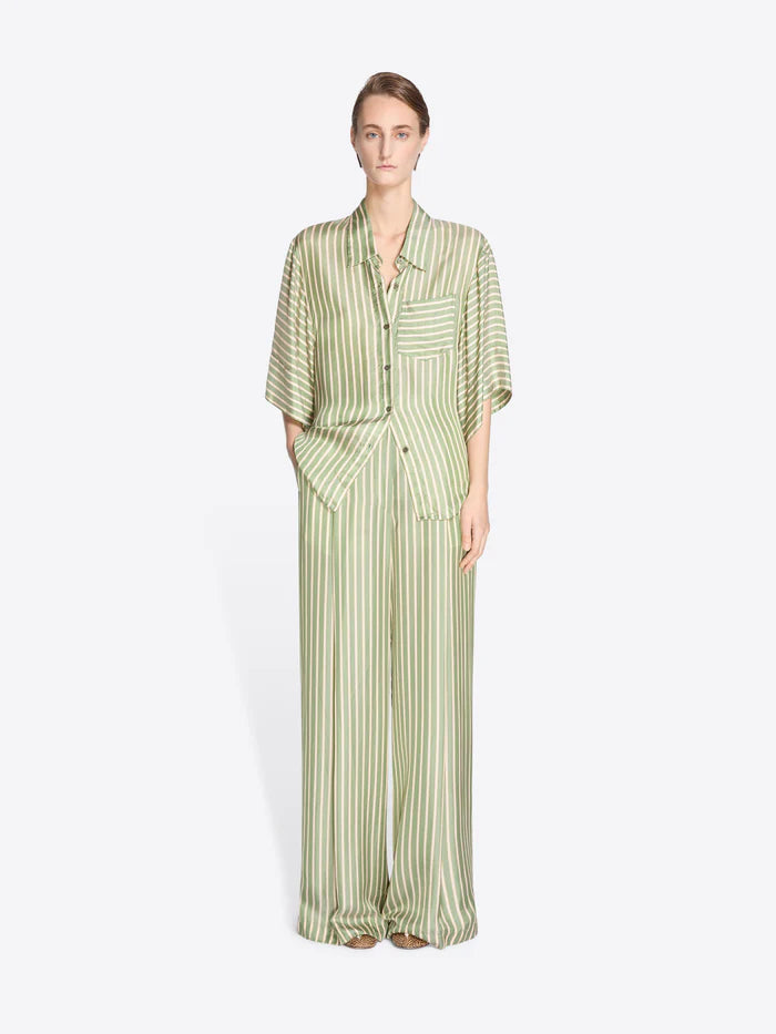Woman wearing a green and white striped outfit on a white background