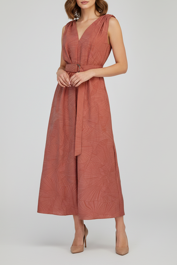 Woman wearing a rust-colored sleeveless dress on a white background