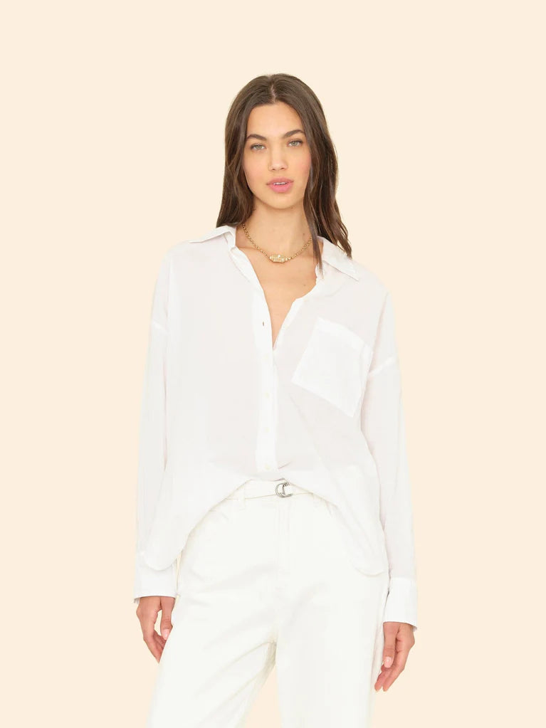 Woman wearing a white shirt and pants on a beige background