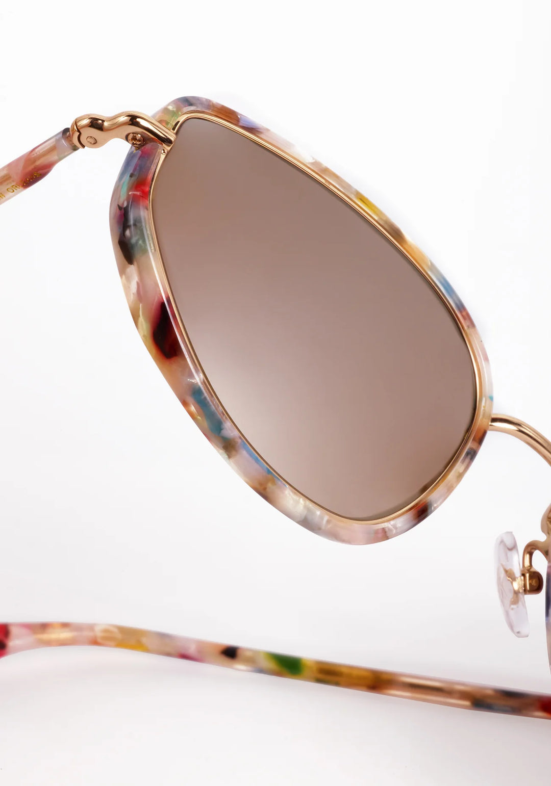 Sunglasses with colorful frame and brown lens on a white background