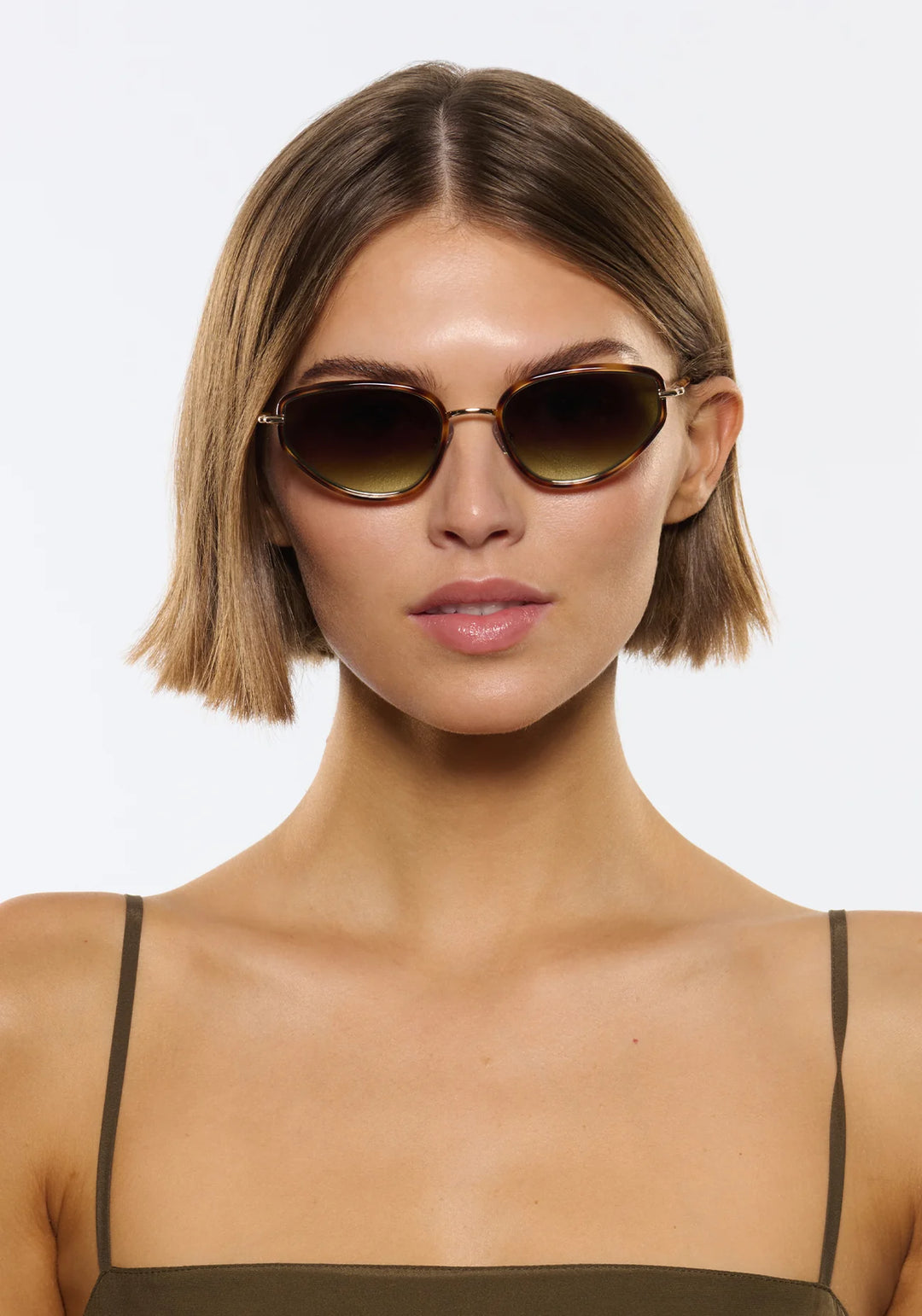 Woman wearing sunglasses with a plain background