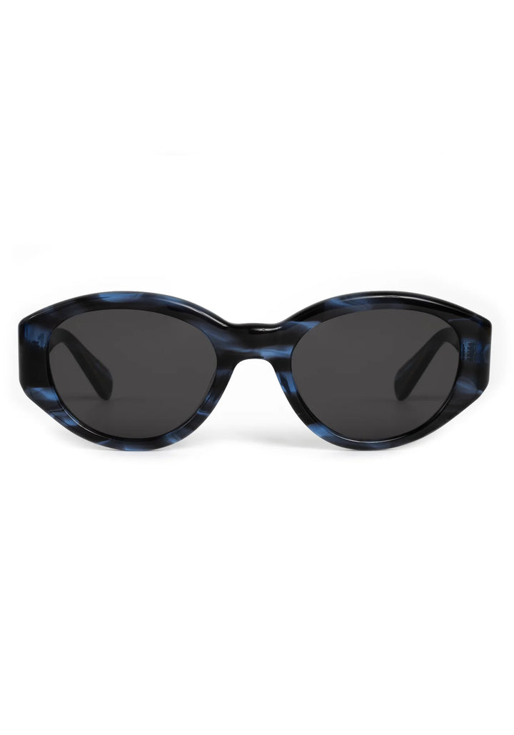 Sunglasses with blue tortoiseshell frame and dark lenses on a white background