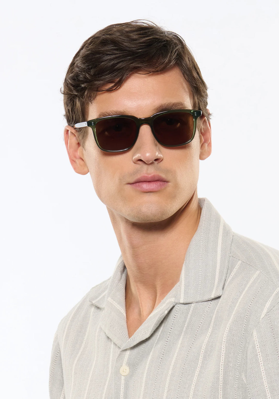 Man wearing sunglasses with a neutral background