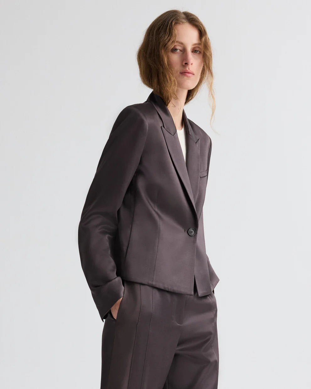 Woman wearing a gray suit on a white background