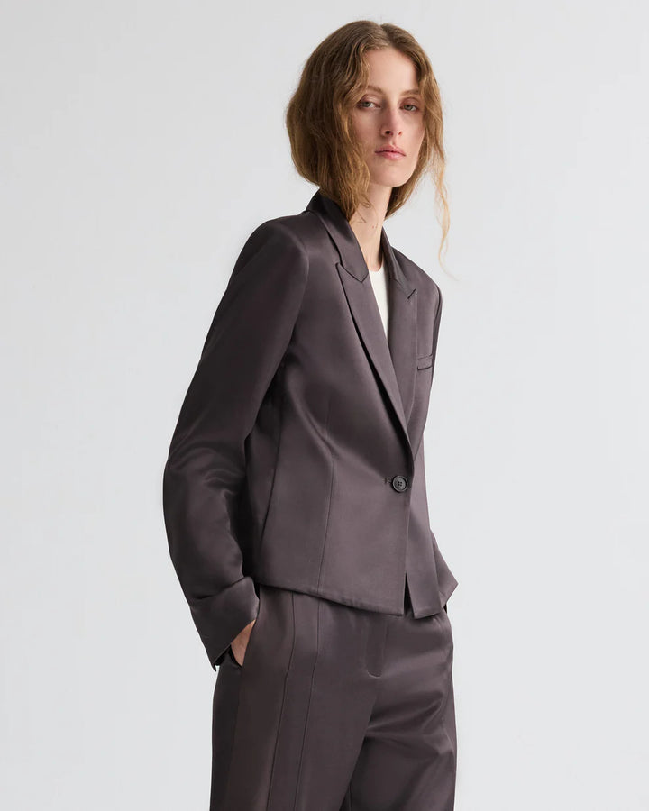 Woman wearing a gray suit on a white background