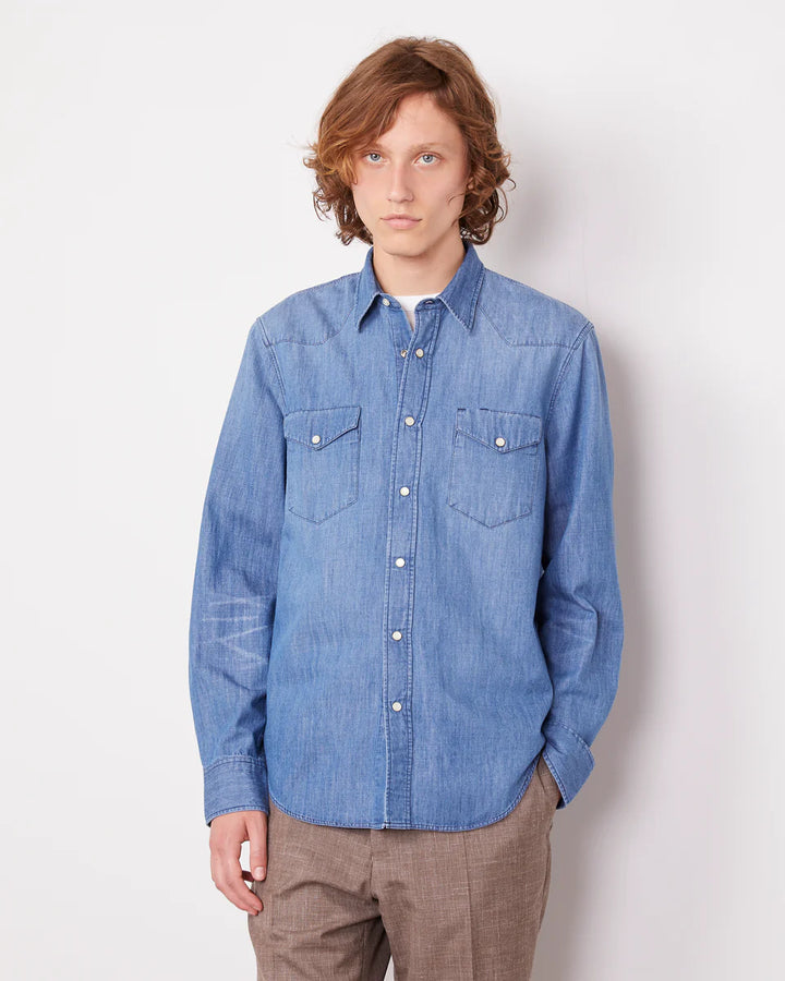 Person wearing a blue denim shirt against a white background