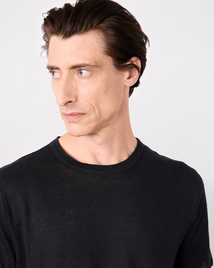 Man wearing a black shirt against a white background