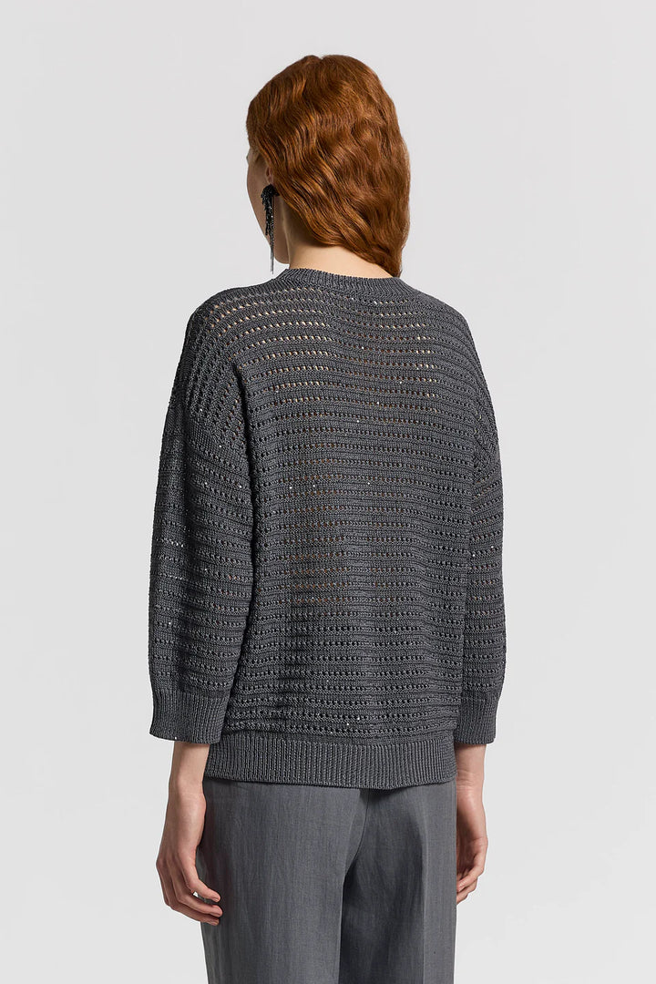 Person wearing a gray textured sweater on a light gray background