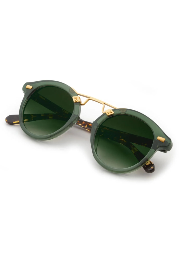 Green sunglasses with gold frames on a white background