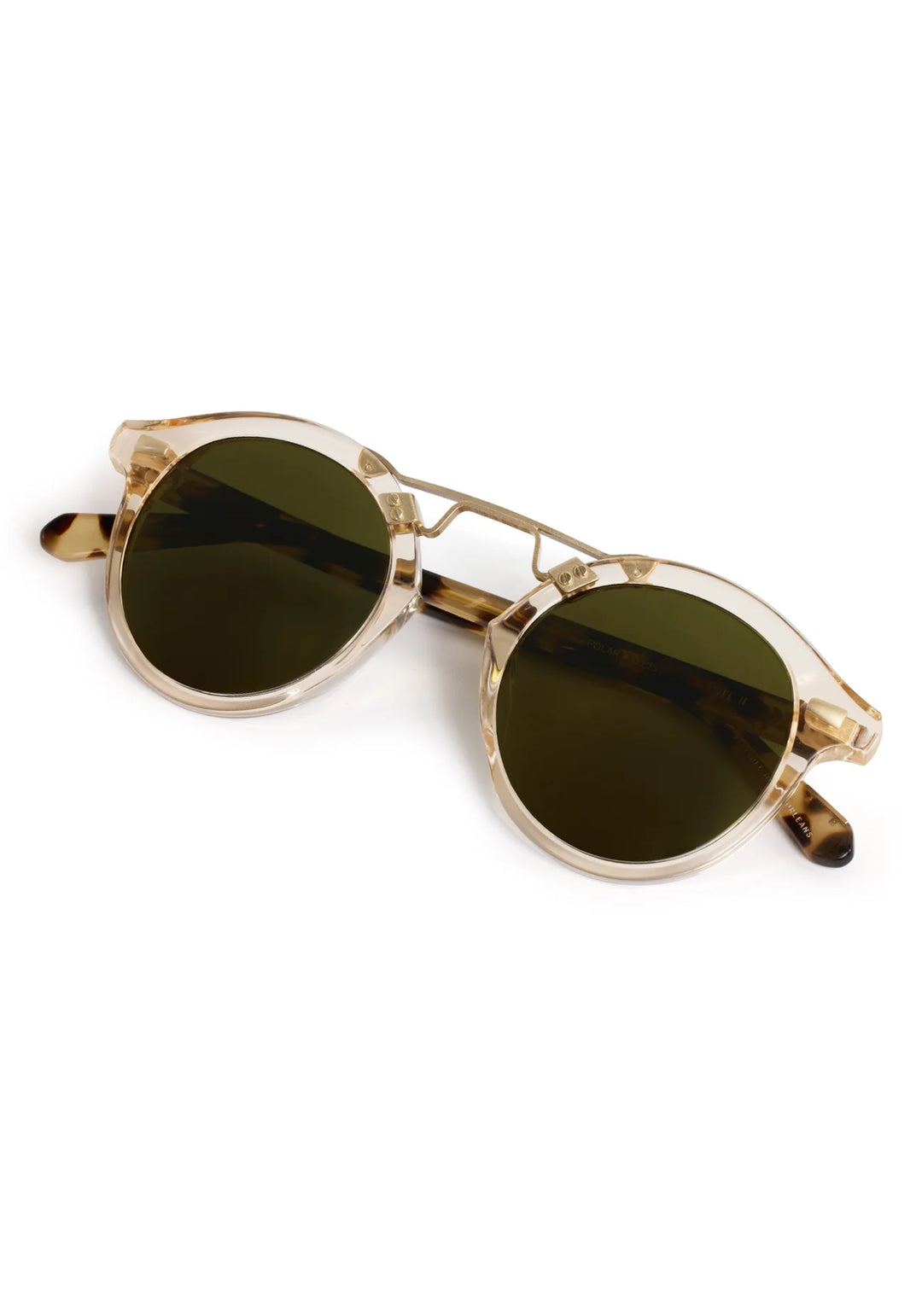 Gold-framed sunglasses with green lenses on a white background