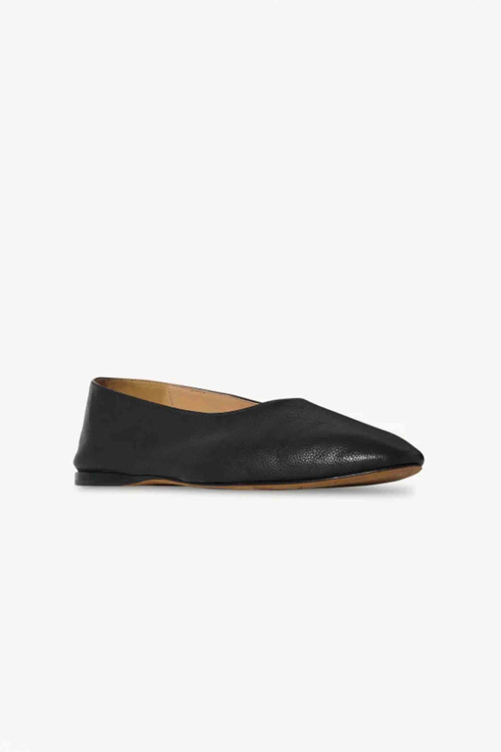 Black leather flat shoe on a white background