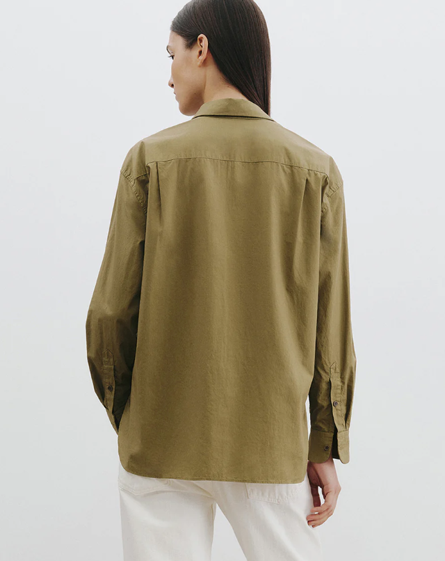 Person wearing a green shirt on a white background